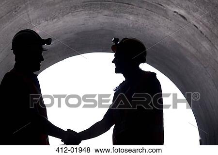 Silhouette of workers shaking hands in tunnel View Large Photo Image Stock Photo - Silhouette of workers shaking hands in tunnel. Fotosearch