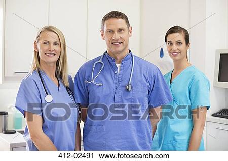 Smiling veterinarians standing together in vet's surgery View Large Photo Image Stock Image - Smiling veterinarians standing together in vet's surgery. Fotosearch