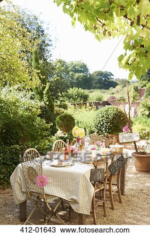 Stock Image - Table set for outdoor wedding reception. Fotosearch