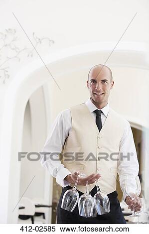 Waiter carrying wine glasses in restaurant View Large Photo Image Stock Photography - Waiter carrying wine glasses in restaurant. Fotosearch