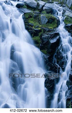 Waterfall rushing over rocky hillside View Large Photo Image Stock Image - Waterfall rushing over rocky hillside. Fotosearch