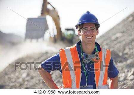 Worker smiling in quarry View Large Photo Image Stock Photo - Worker smiling in quarry. Fotosearch