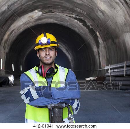 Worker standing in tunnel View Large Photo Image Stock Image - Worker standing in tunnel. Fotosearch