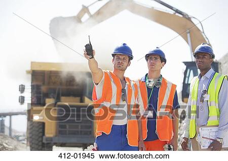 Workers and businessman standing in quarry View Large Photo Image Stock Photography - Workers and businessman standing in quarry. Fotosearch