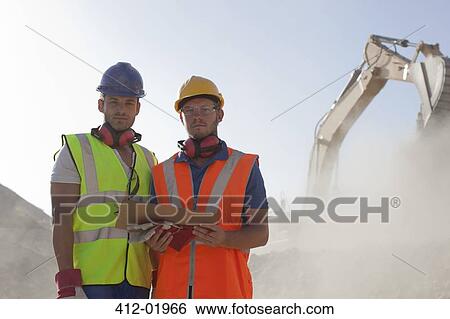 Stock Photograph - Workers standing in quarry. Fotosearch