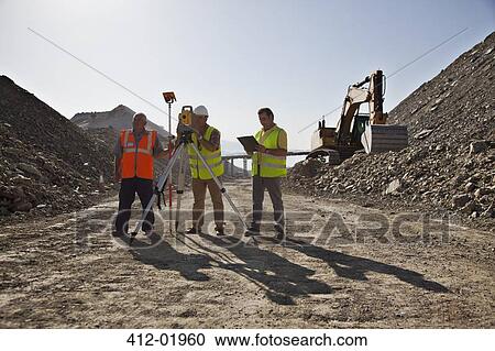 Workers using leveling machinery in quarry View Large Photo Image Stock Image - Workers using leveling machinery in quarry. Fotosearch