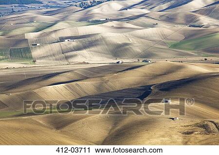 Stock Image - Aerial view of rolling hills in dry rural landscape. Fotosearch