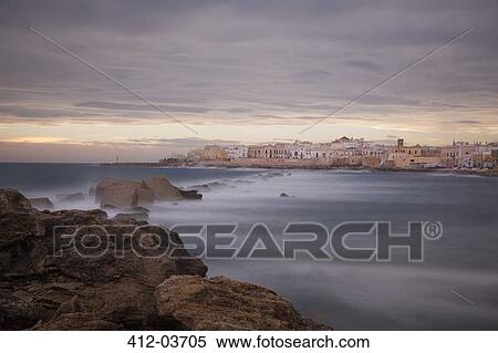 Stock Photography - Blurred view of waves rolling over rock formations. Fotosearch