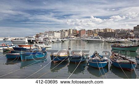 Boats docked in urban harbor View Large Photo Image Stock Photography - Boats docked in urban harbor. Fotosearch