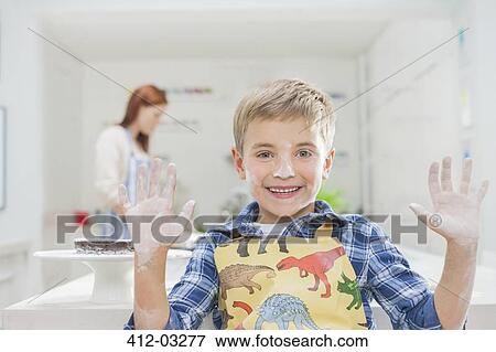 Boy covered in flour in kitchen View Large Photo Image Stock Photo - Boy covered in flour in kitchen. Fotosearch