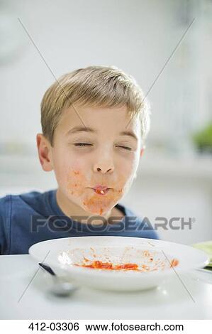 Boy slurping spaghetti at table View Large Photo Image Stock Photograph - Boy slurping spaghetti at table. Fotosearch