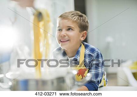 Boy smiling in kitchen View Large Photo Image Stock Image - Boy smiling in kitchen. Fotosearch