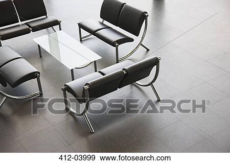 Stock Photo - Chairs and table in office lobby area. Fotosearch