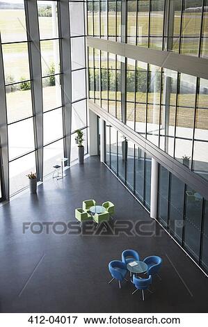 Stock Photo - Chairs and table in office lobby area. Fotosearch