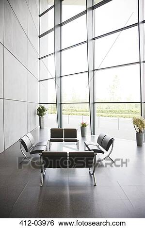 Chairs and table in office lobby area View Large Photo Image Stock Photograph - Chairs and table in office lobby area. Fotosearch