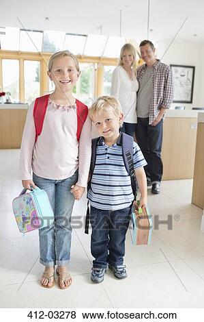 Stock Photo - Children ready for school in kitchen. Fotosearch