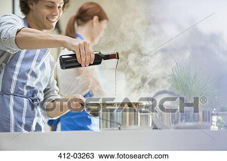 Couple cooking in kitchen View Large Photo Image Stock Image - Couple cooking in kitchen. Fotosearch