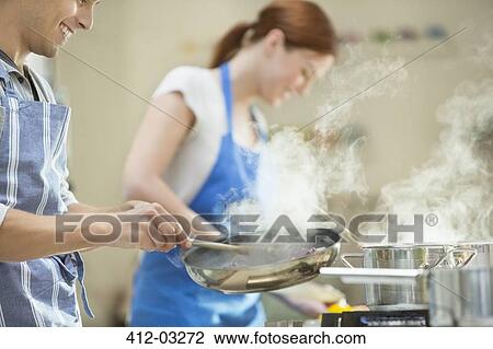 Couple cooking in kitchen View Large Photo Image Stock Image - Couple cooking in kitchen. Fotosearch