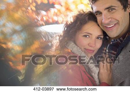 Couple hugging in park View Large Photo Image Stock Photo - Couple hugging in park. Fotosearch