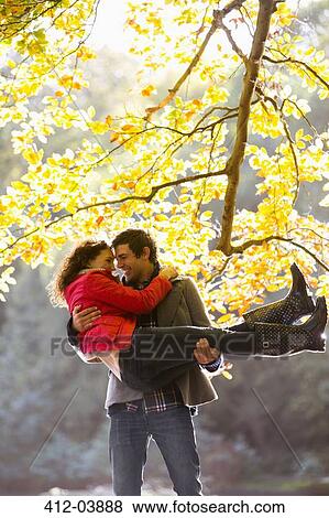 Couple playing together in park View Large Photo Image Stock Photo - Couple playing together in park. Fotosearch