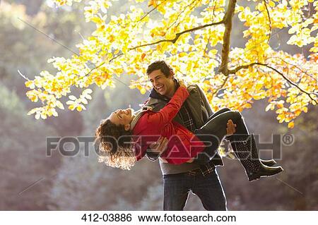Stock Photograph - Couple playing together in park. Fotosearch