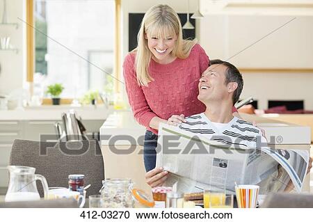 Couple reading newspaper at breakfast View Large Photo Image Stock Image - Couple reading newspaper at breakfast. Fotosearch