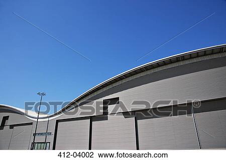 Curved roof of warehouse and blue sky View Large Photo Image Stock Image - Curved roof of warehouse and blue sky. Fotosearch