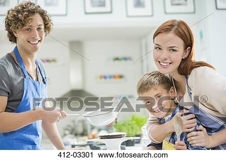 Family cooking together in kitchen View Large Photo Image Stock Image - Family cooking together in kitchen. Fotosearch