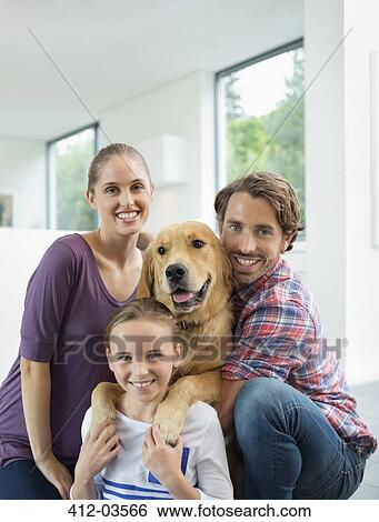 Family smiling with dog indoors View Large Photo Image Stock Photograph - Family smiling with dog indoors. Fotosearch