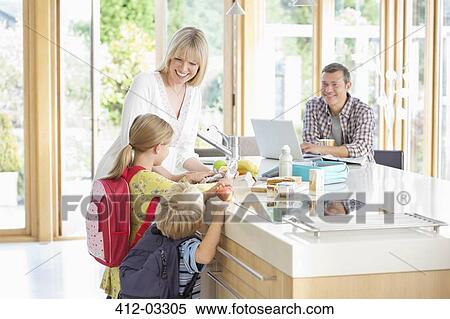 Stock Photography - Family talking in kitchen. Fotosearch