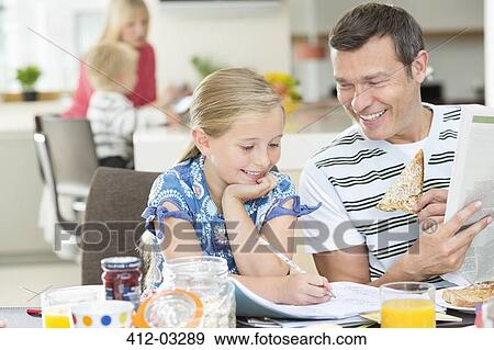 Stock Photo - Father and daughter having breakfast. Fotosearch