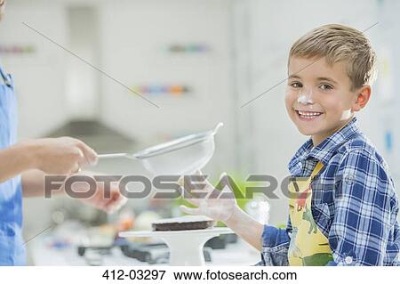 Stock Photo - Father and son baking in kitchen. Fotosearch