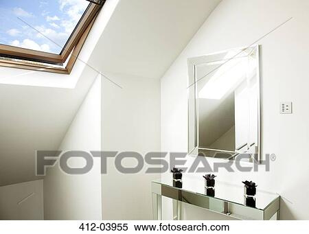 Stock Photography - Mirror and table in attic room. Fotosearch