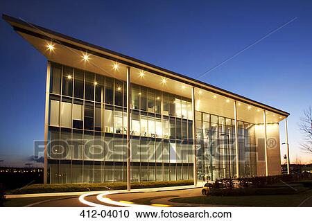 Stock Image - Modern building illuminated at night. Fotosearch