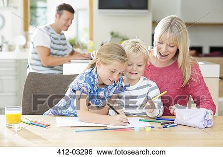 Stock Photograph - Mother and children coloring at table. Fotosearch