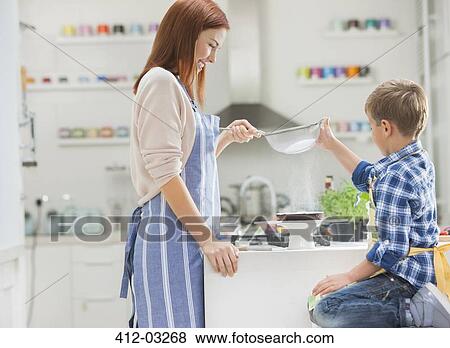 Mother and son baking in kitchen View Large Photo Image Stock Photo - Mother and son baking in kitchen. Fotosearch