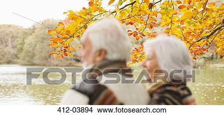 Picture - Older couple standing in park. Fotosearch