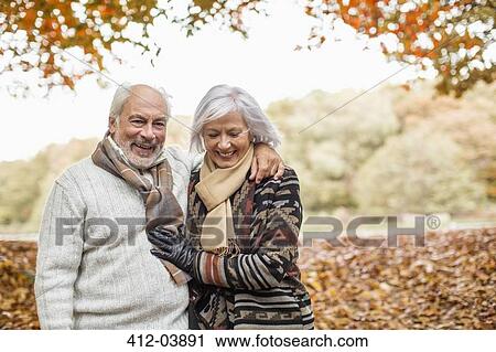 Older couple walking in park View Large Photo Image Stock Image - Older couple walking in park. Fotosearch