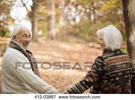 Older couple walking in park View Large Photo Image Stock Photo - Older couple walking in park. Fotosearch