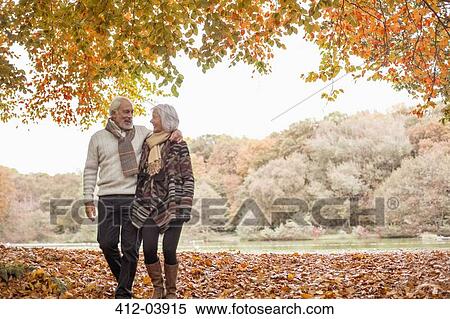 Older couple walking in park View Large Photo Image Stock Photography - Older couple walking in park. Fotosearch