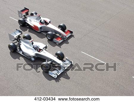 Race cars driving on track View Large Photo Image Picture - Race cars driving on track. Fotosearch