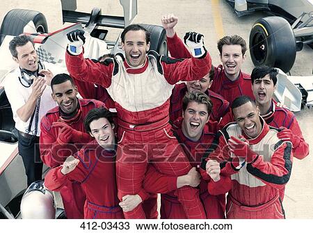 Racer and team cheering in garage View Large Photo Image Stock Image - Racer and team cheering in garage. Fotosearch