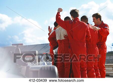 Racer and team cheering on track View Large Photo Image Stock Photo - Racer and team cheering on track. Fotosearch