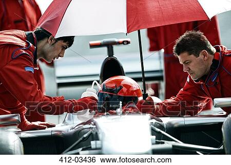 Racer and team working in pit stop View Large Photo Image Stock Photograph - Racer and team working in pit stop. Fotosearch