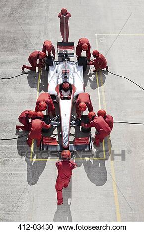 Stock Image - Racing team working at pit stop. Fotosearch
