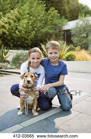 Smiling children petting dog outdoors View Large Photo Image Stock Photography - Smiling children petting dog outdoors. Fotosearch