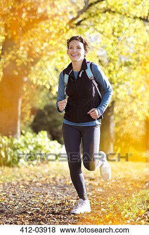 Woman running in park View Large Photo Image Stock Photo - Woman running in park. Fotosearch