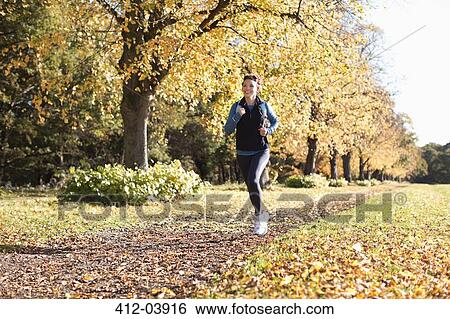 Woman running in park View Large Photo Image Stock Photograph - Woman running in park. Fotosearch