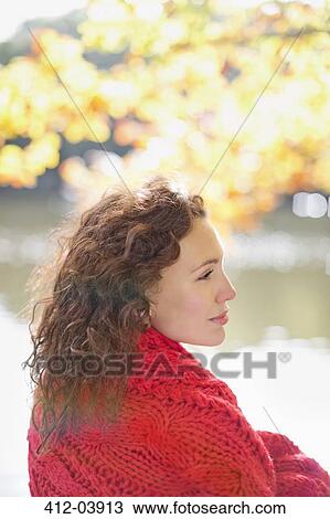 Woman wrapped in blanket in park View Large Photo Image Stock Image - Woman wrapped in blanket in park. Fotosearch