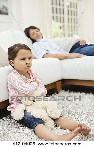 Angry girl watching television with mother View Large Photo Image Stock Photography - Angry girl watching television with mother. Fotosearch